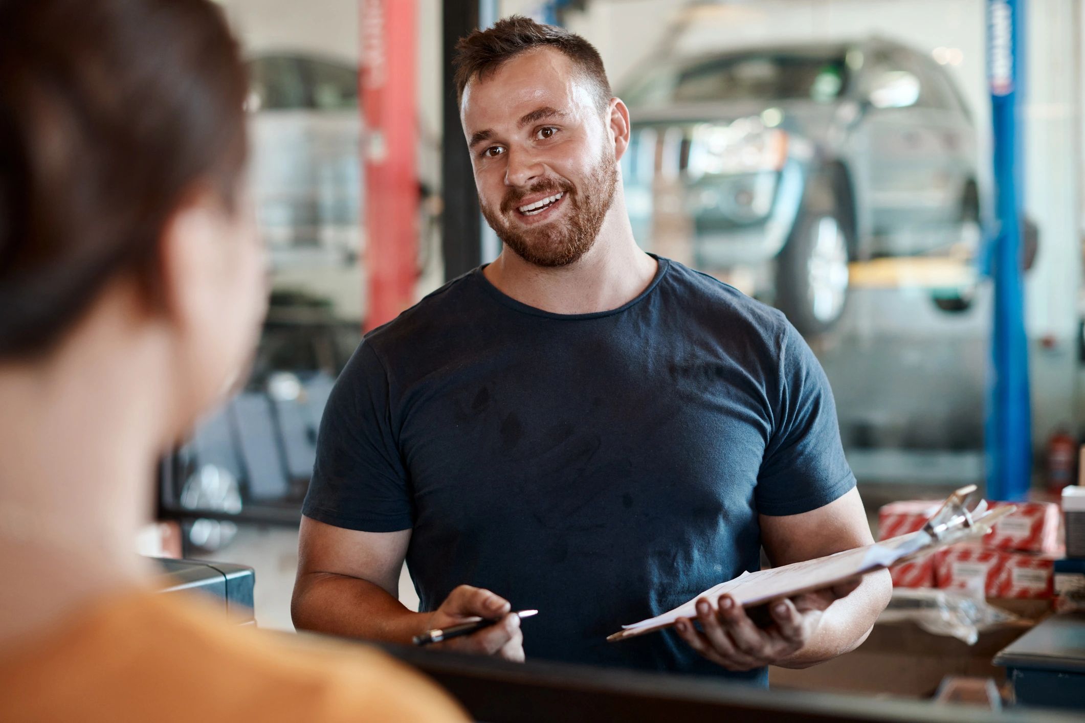 Customer talking with mechanic at service counter
