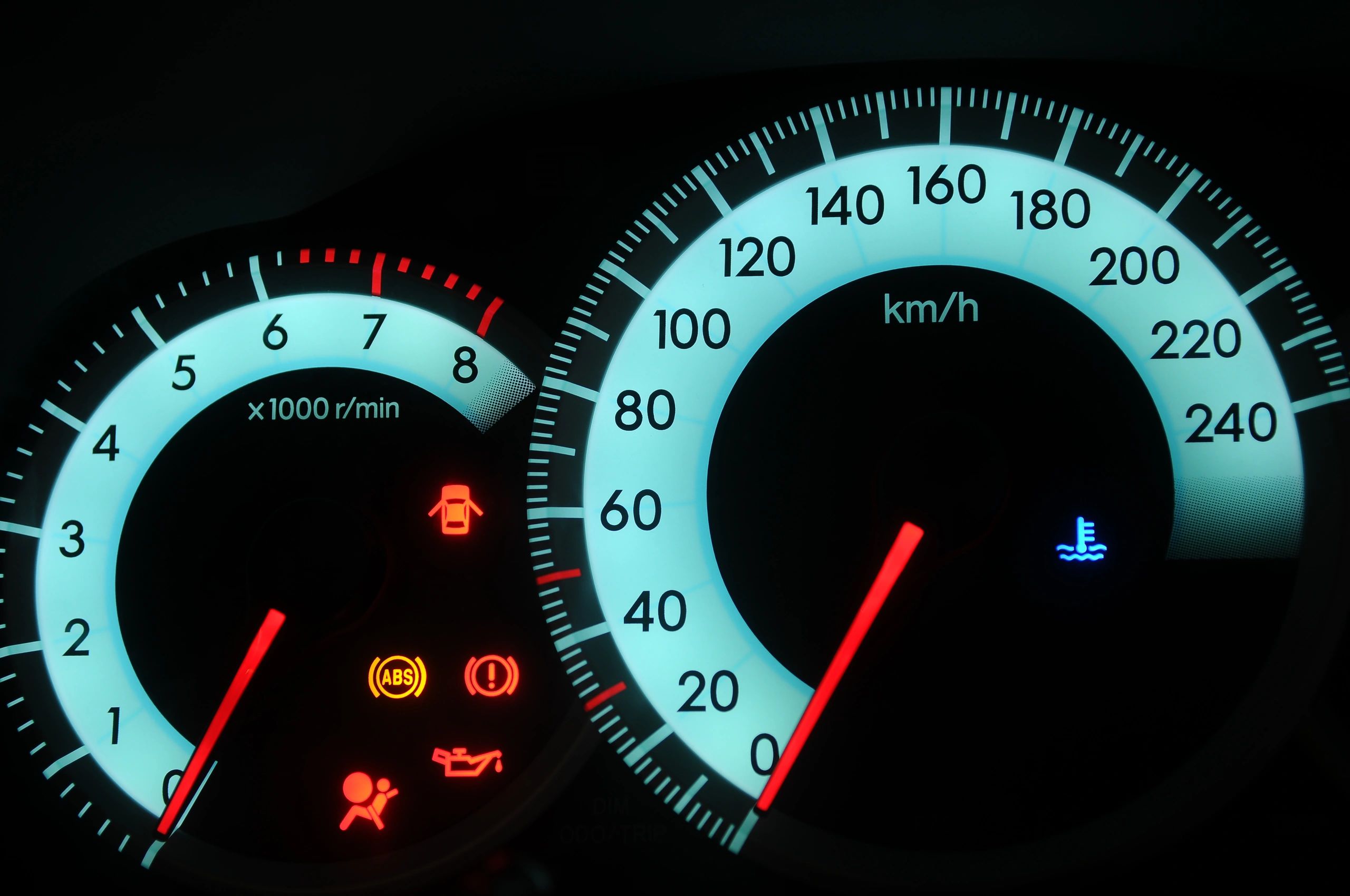 Close-up of a car dashboard with warning lights