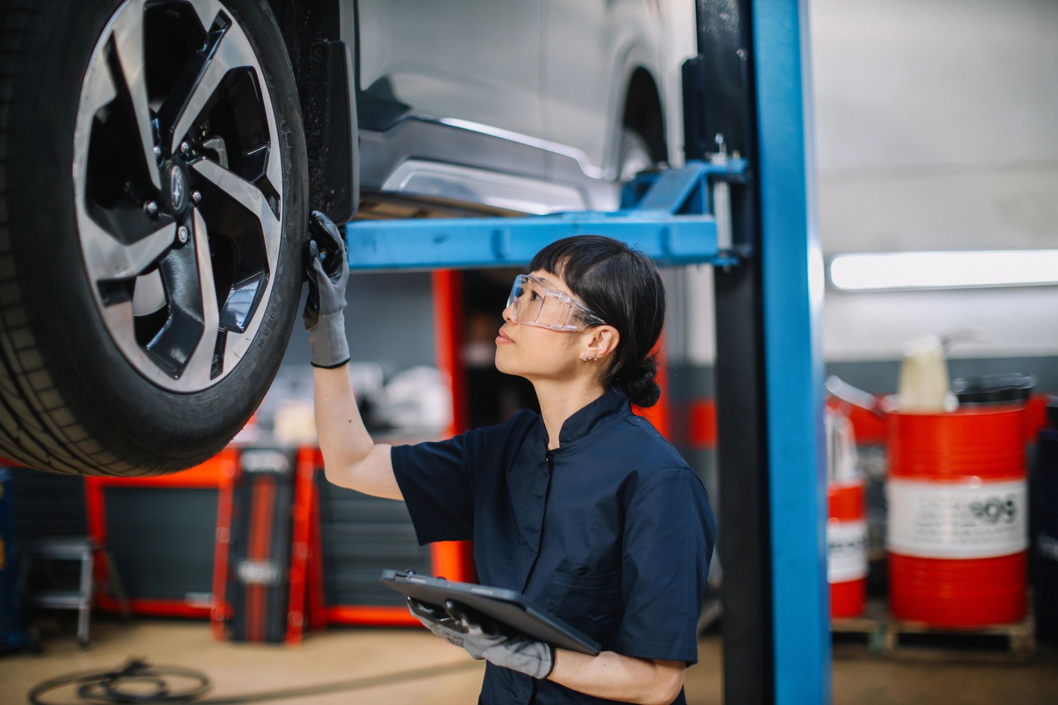 Mechanic reviewing maintenance items on a tablet