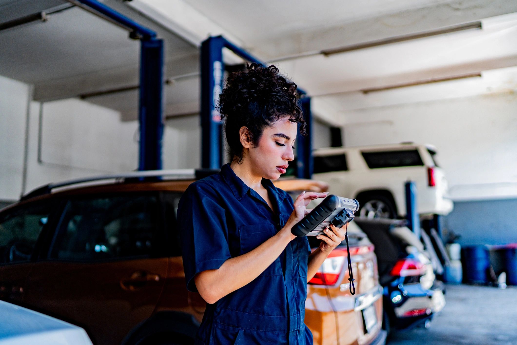 Technician performing diagnostic scan on a vehicle