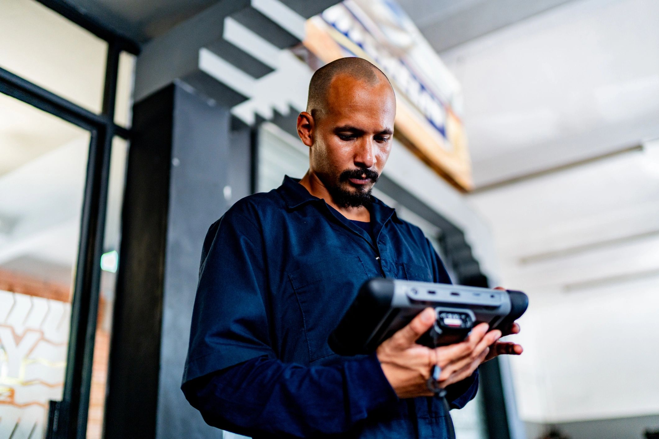 Technician using an OBD scanner to diagnose a Japanese vehicle