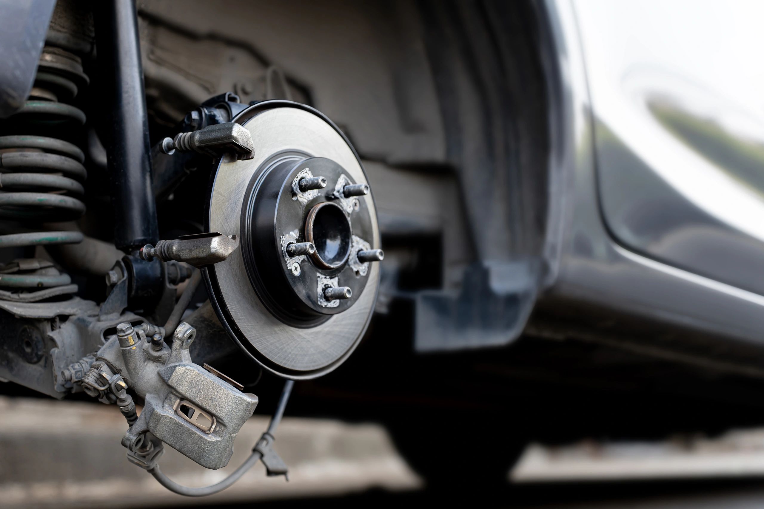 Close-up of brake rotor and caliper during service